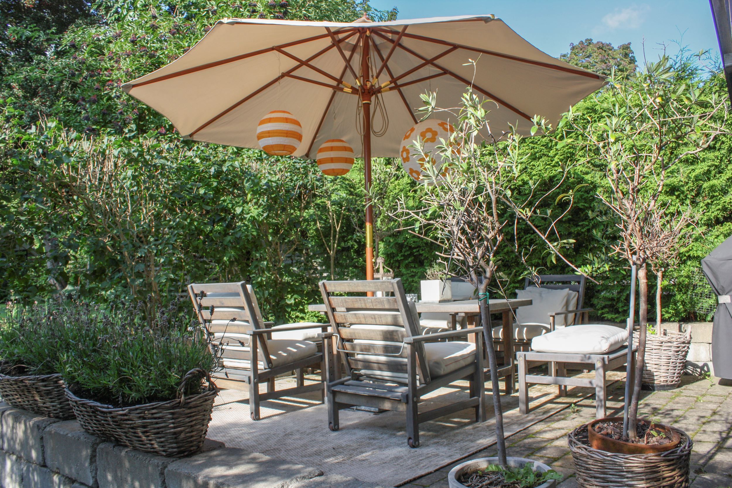 Inbäddad i tät grönska njuter man av uteplatsen