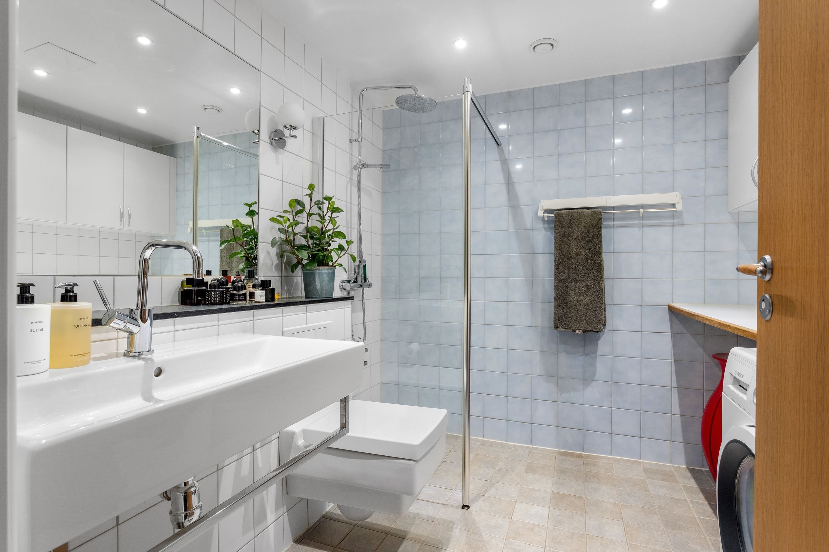 Badrum med dusch bakom glasvägg