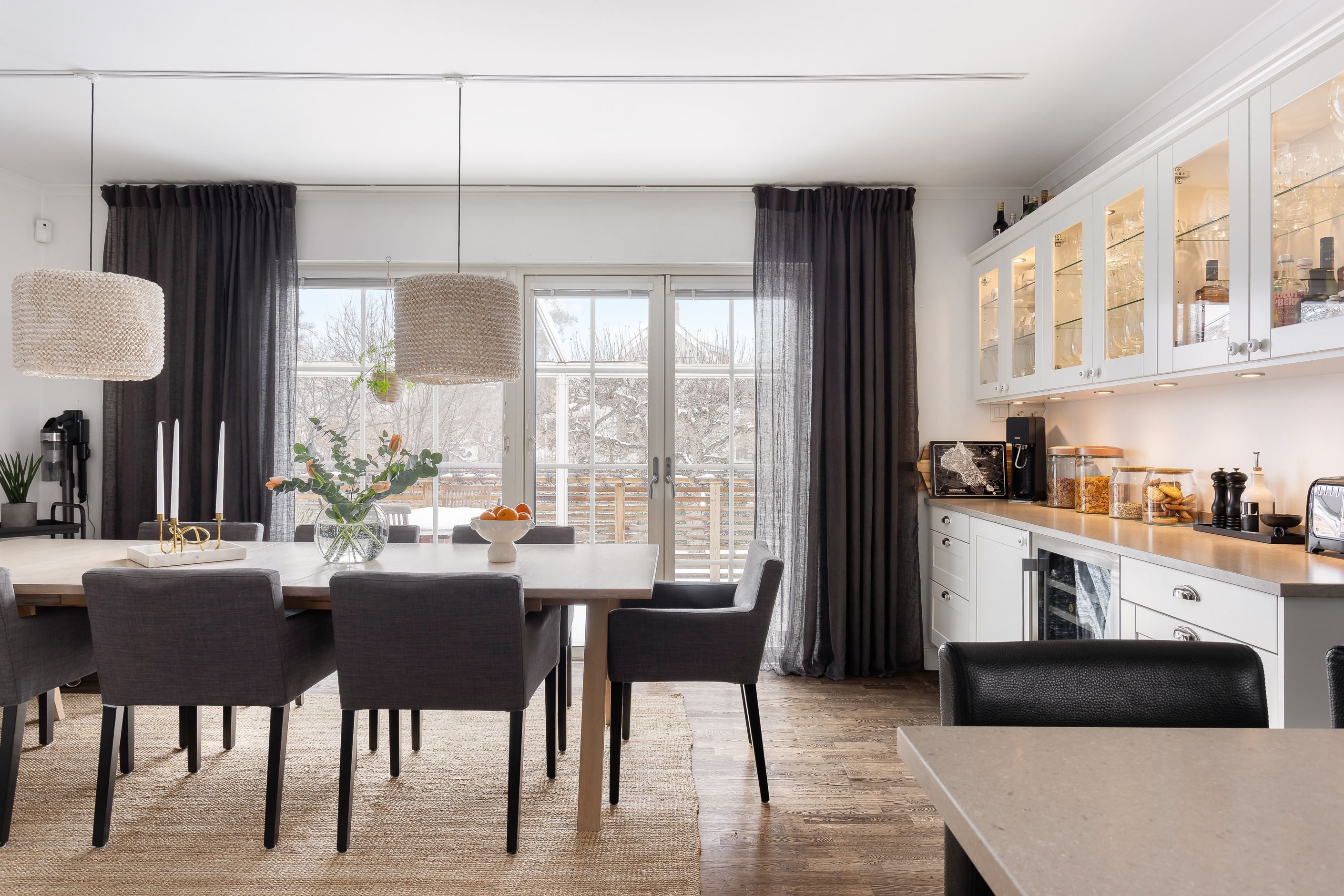 Glasad vägg ut mot altan och vidare binder trivsamt samman hus med trädgård