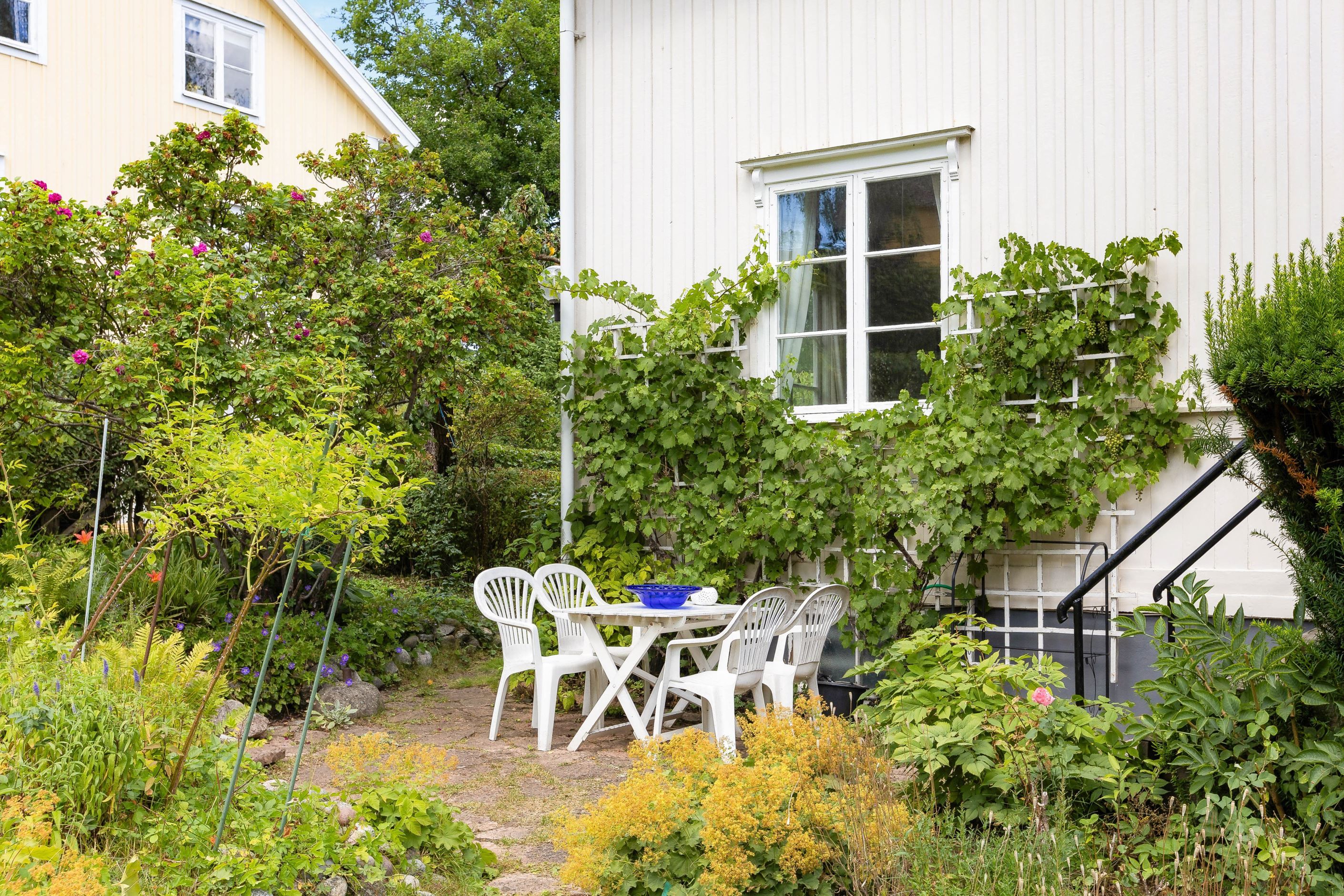 Stensatt uteplats utmed S/V-väggen