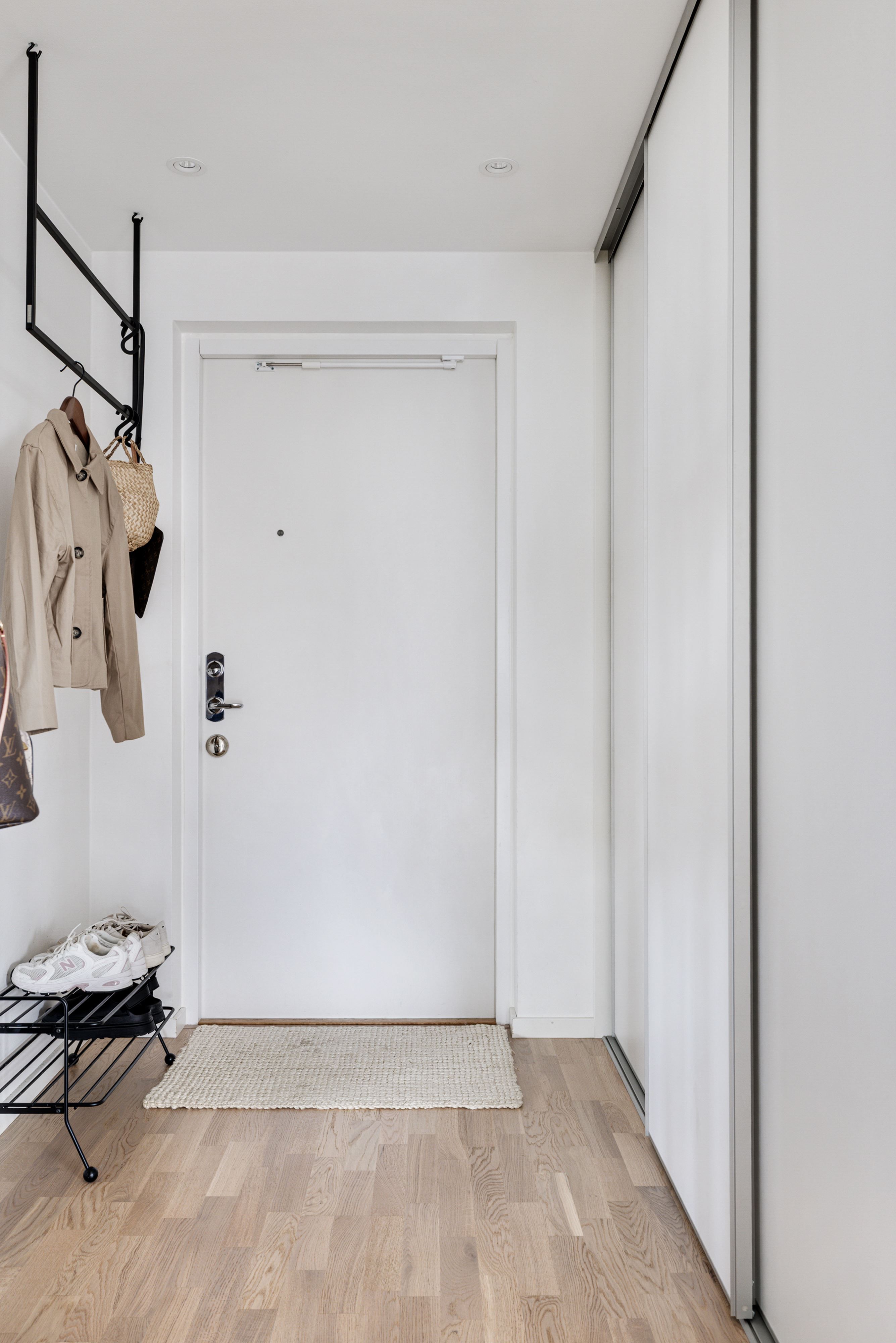 Skjutdörrsgarderoberna i hallen hjälper till med bostadens förvaringsmöjligheter.