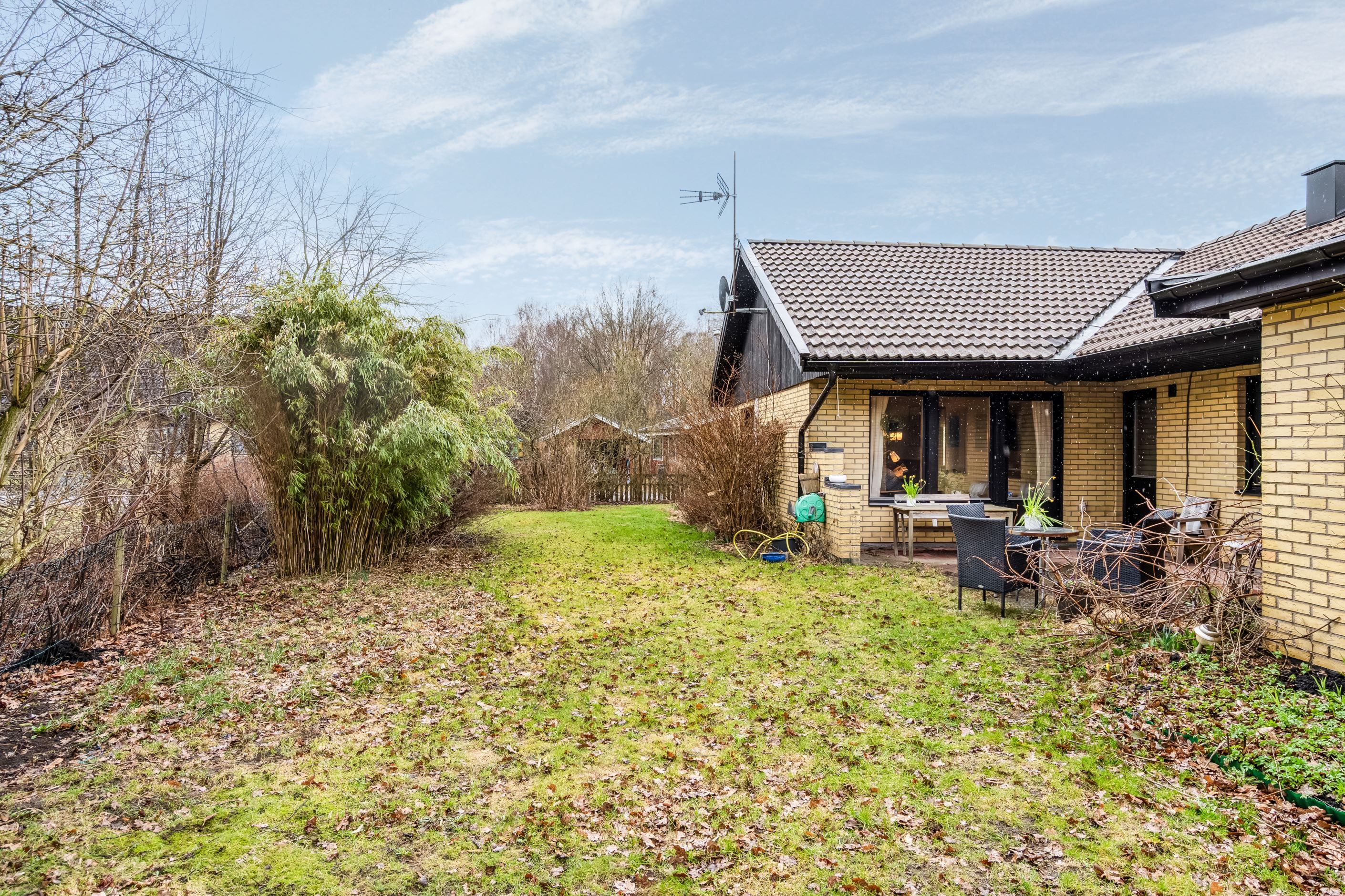 Lättskött trädgård med mycket buskar och gräsytor