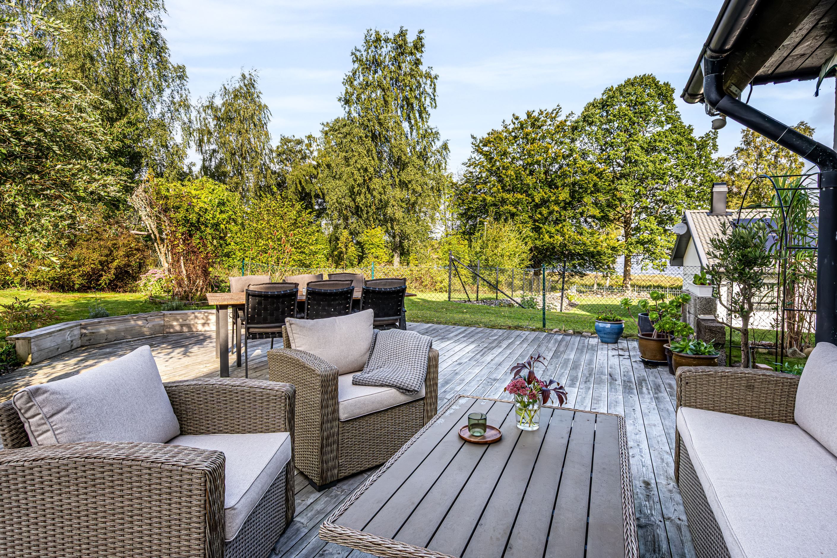 Mysig altan med glimtar av sjön och plats för avkoppling.