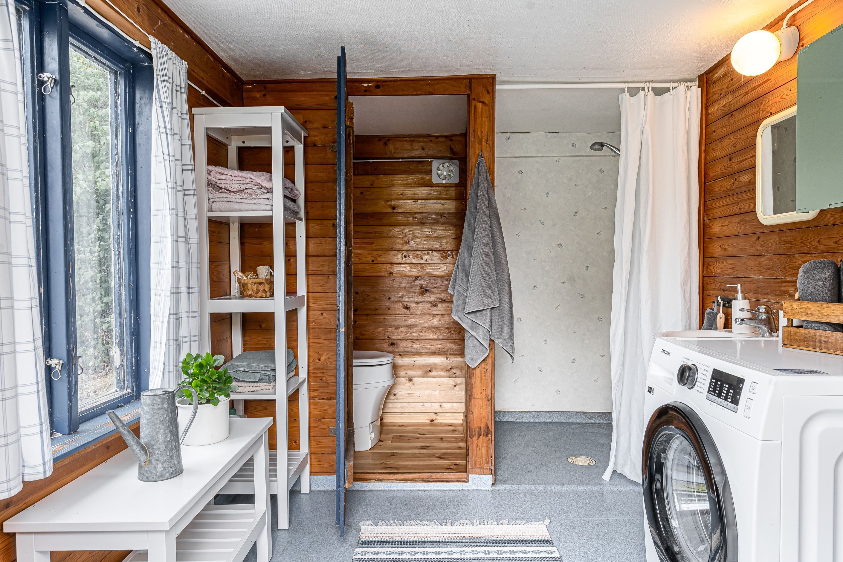 Duschhus med mulltoa och tvättmaskin
