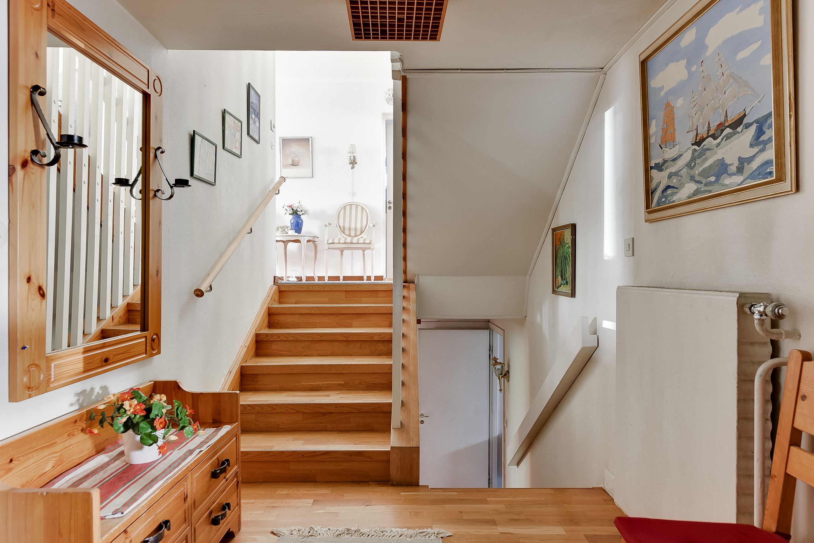 Hall med trappa till mellanplan och källare