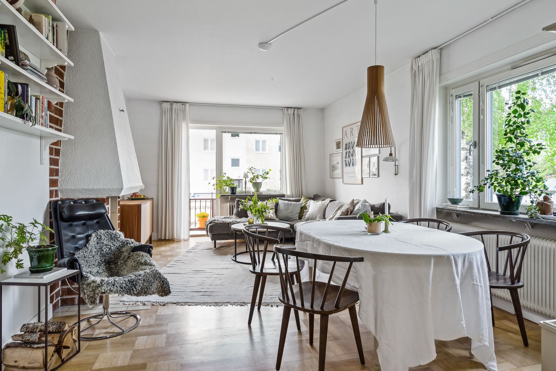 Vardagsrum med salongsdel och dekorativ öppen spis