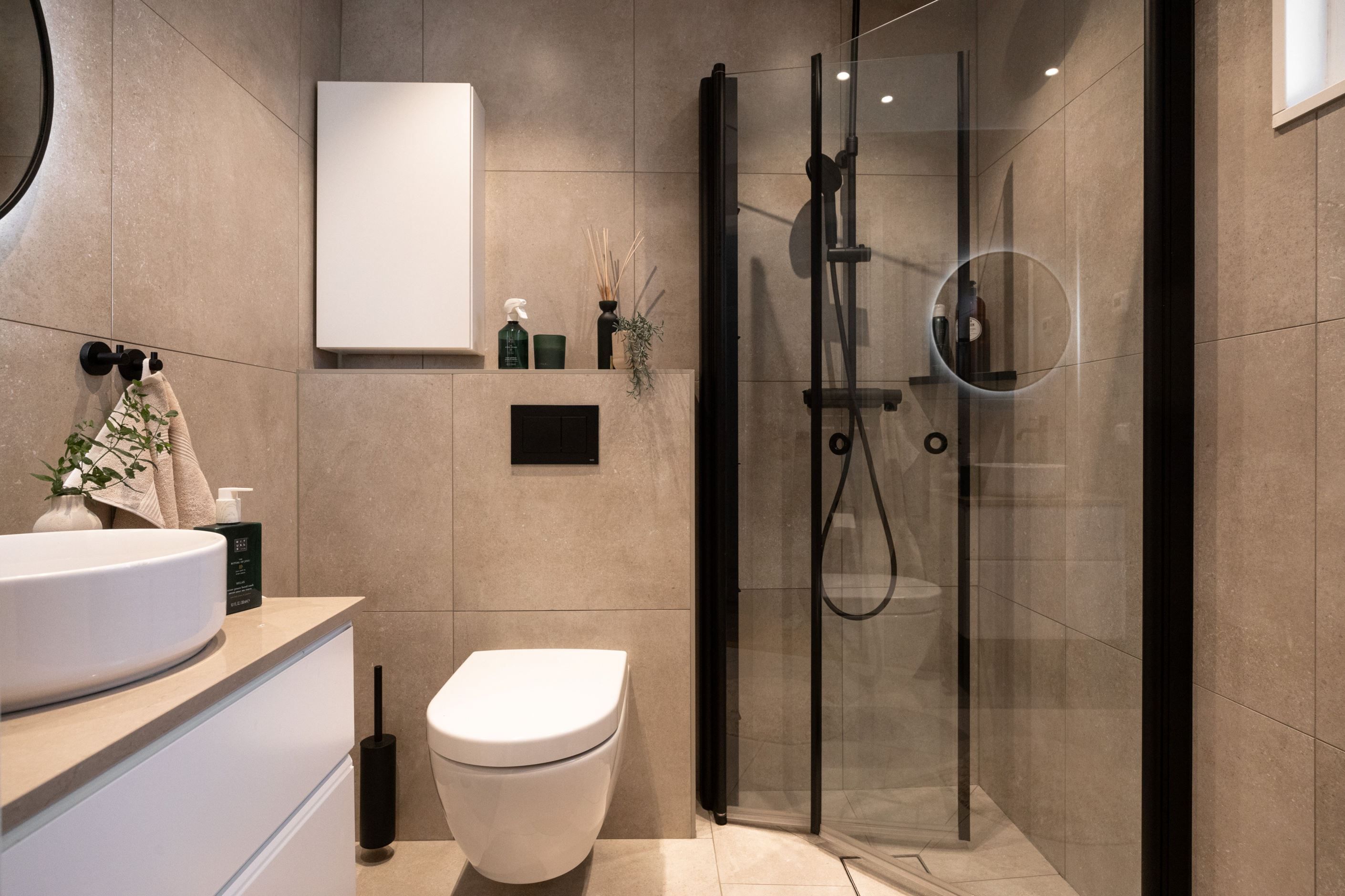 Snyggt helkaklat badrum entréplan.