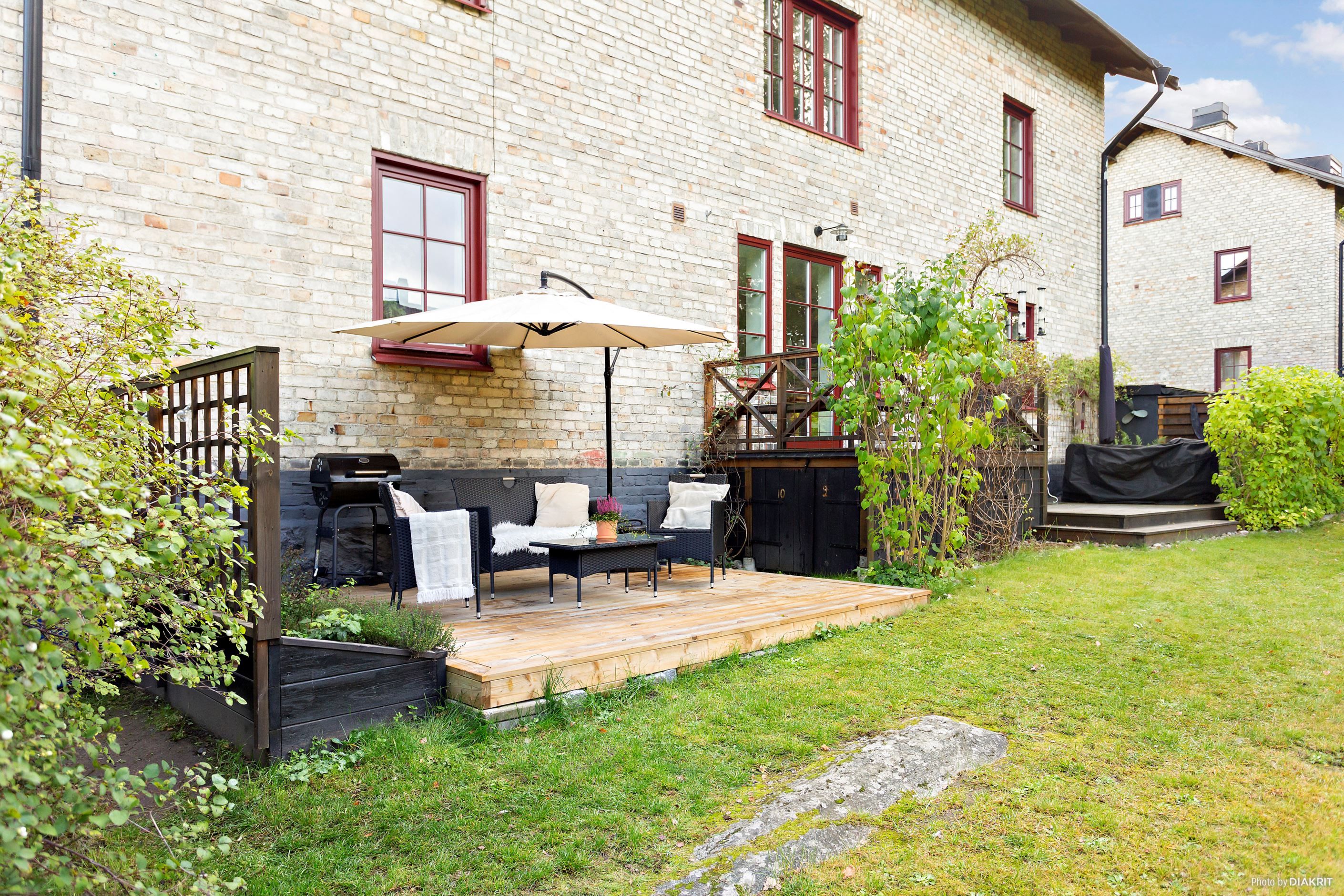 Ljusgult tegel, buskage och plats för odling