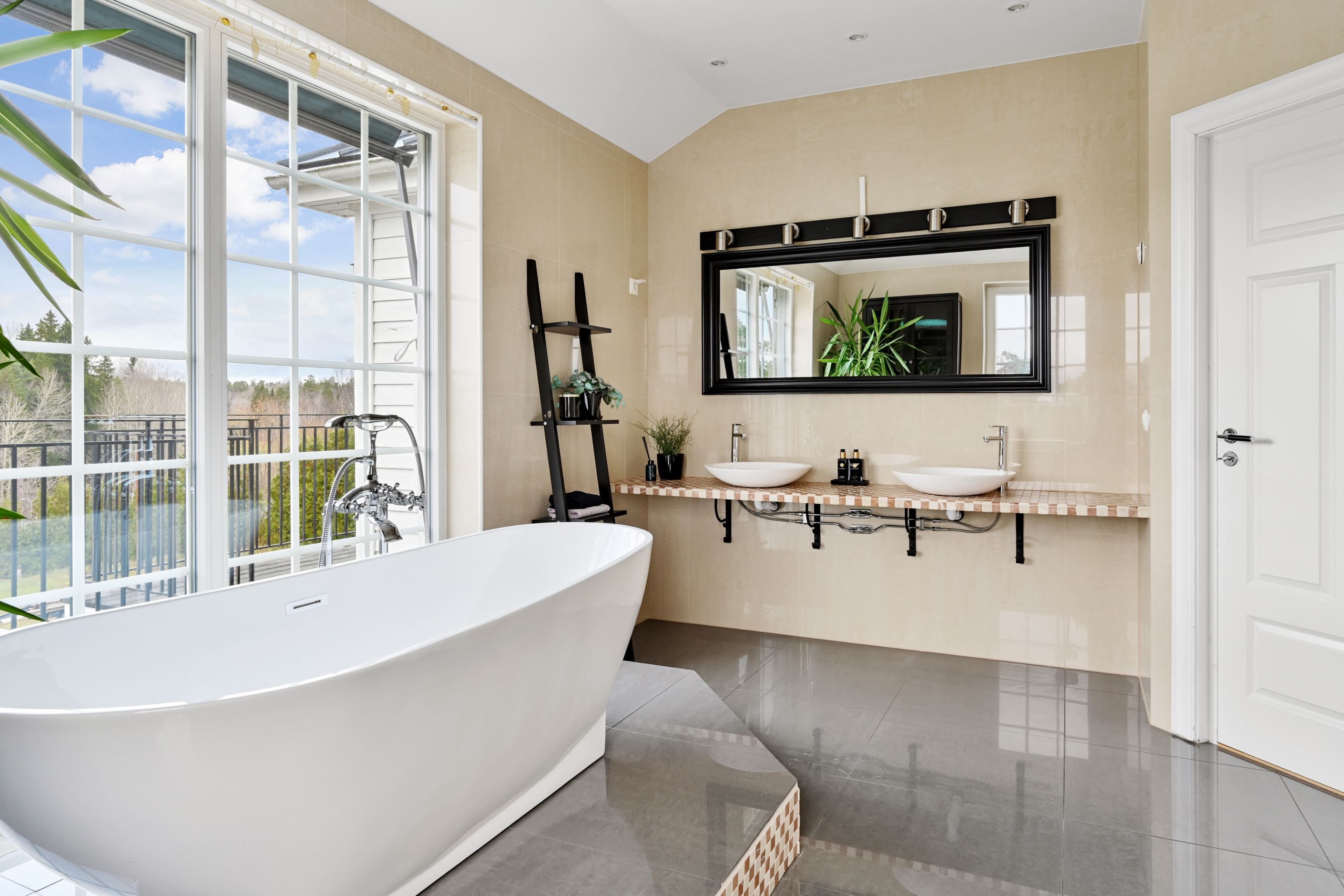 Badrum med badkar och dusch på övre plan