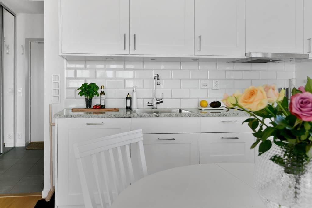 Stilrent kök med vita luckor och lådor