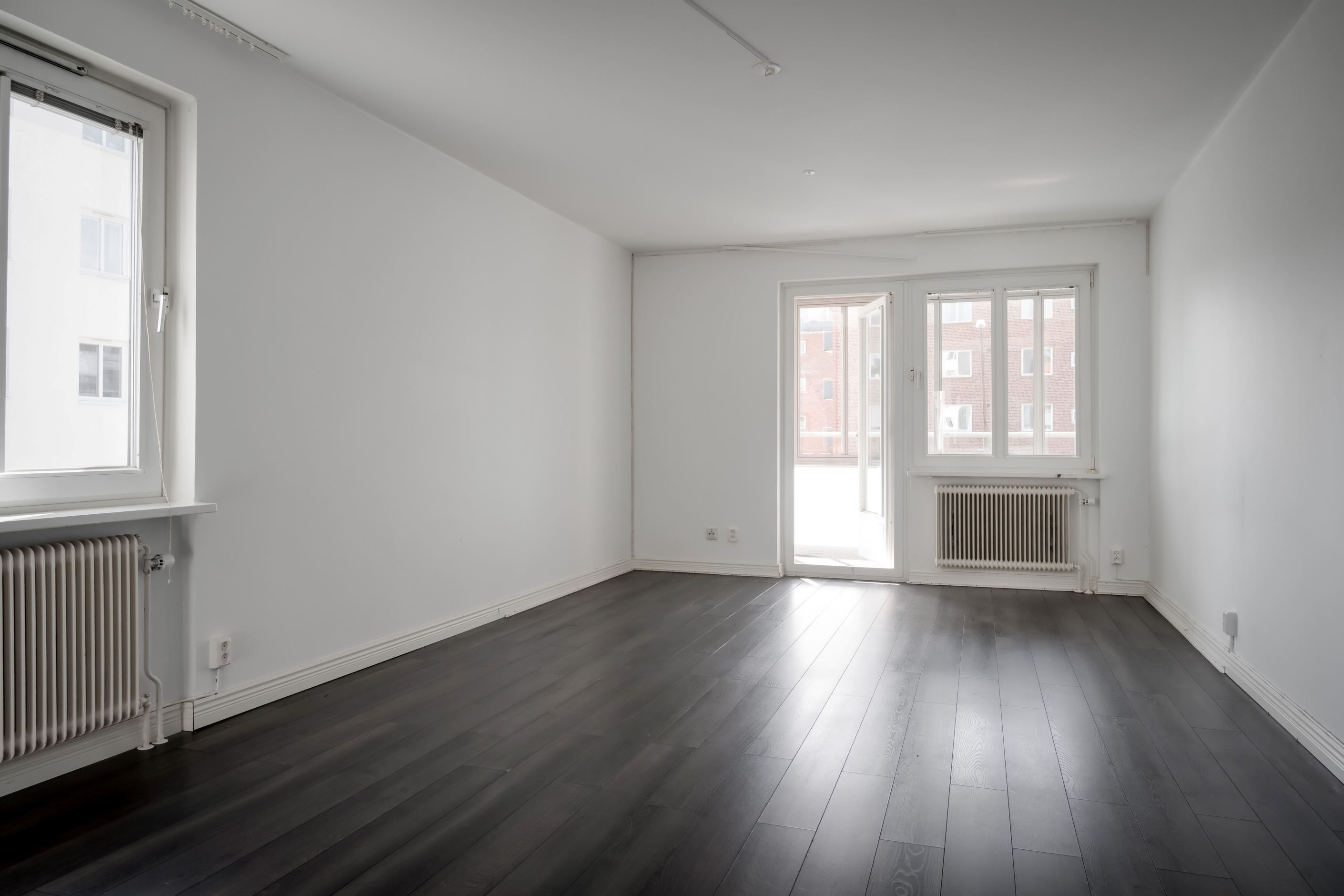 Vardagsrummet är ett luftigt hörnrum med fönster i två riktningar