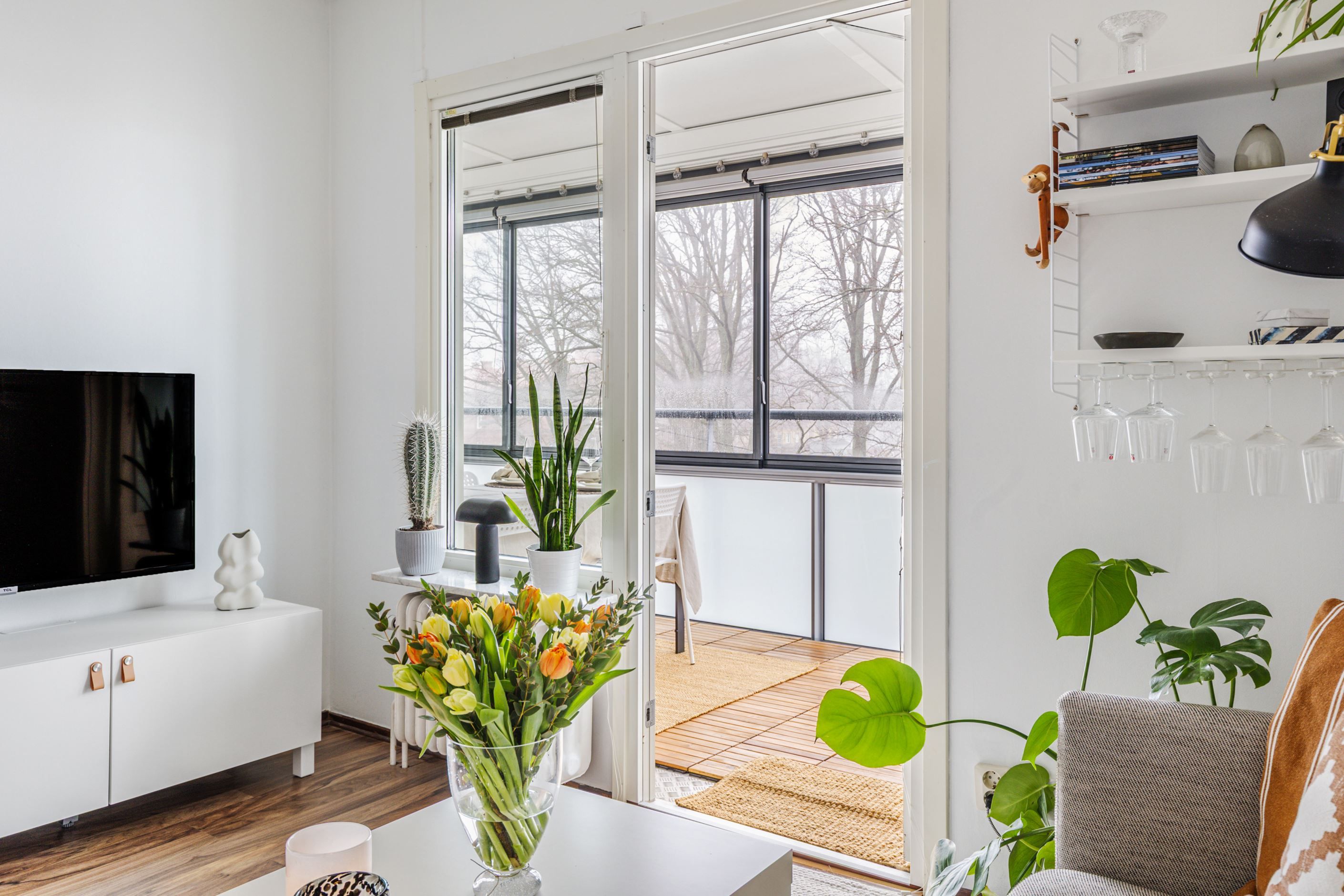 Ljust vardagsrum med utgång till balkong