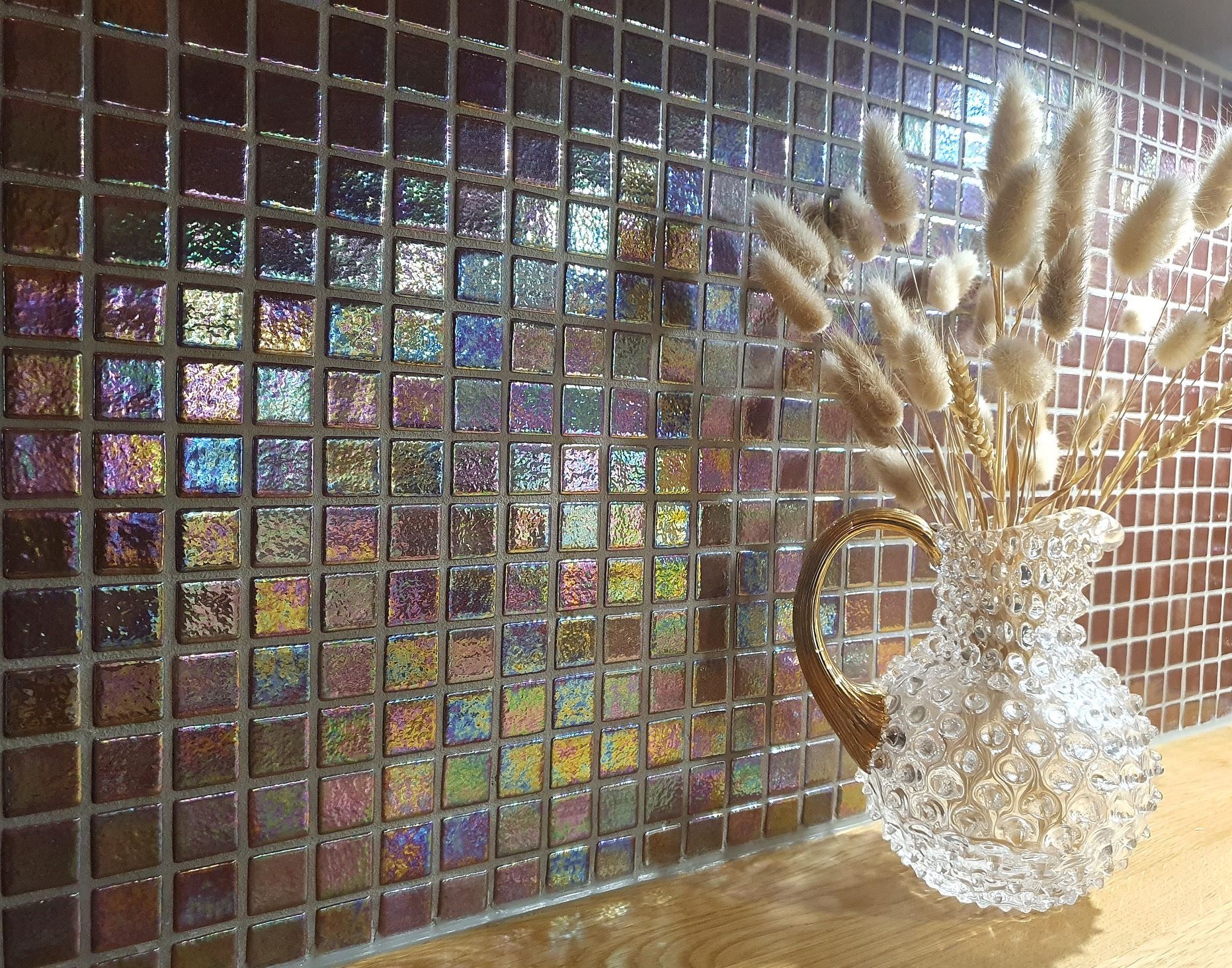 Mosaikbeklädd vägg bakom arbetsbänk