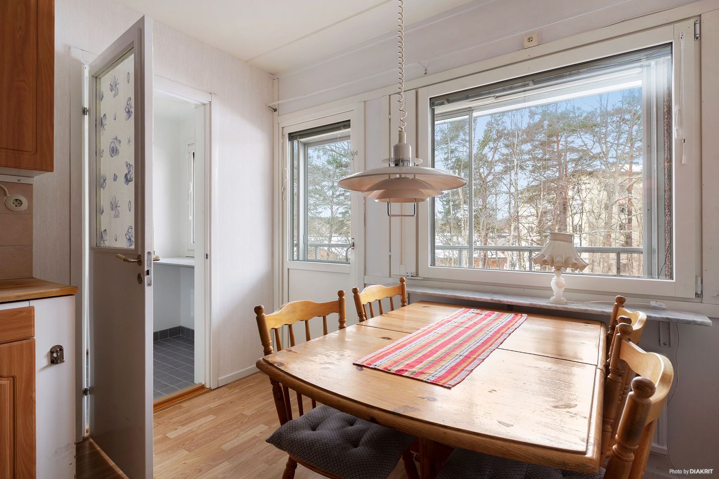 Rymligt kök med matplats med utgång till inglasad balkong