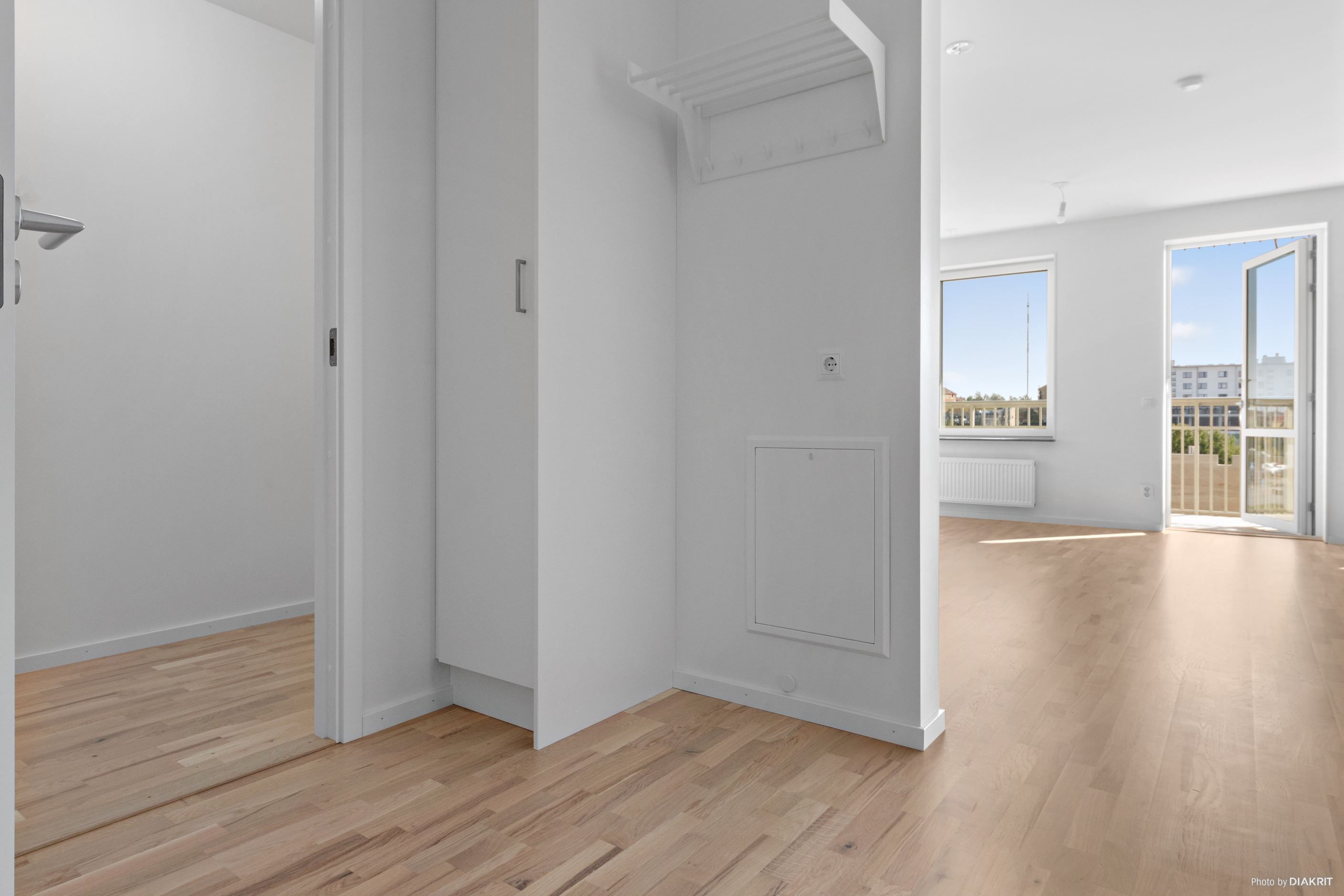 Hall med plats för avhängning av ytterkläder och förvaring i garderober. Ingång till förråd.